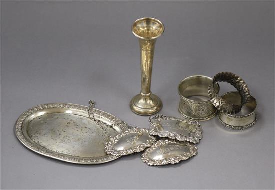 Three silver wine/spirit labels, 3 silver serviette rings, a silver specimen vase and a Thai sterling silver dish (8)